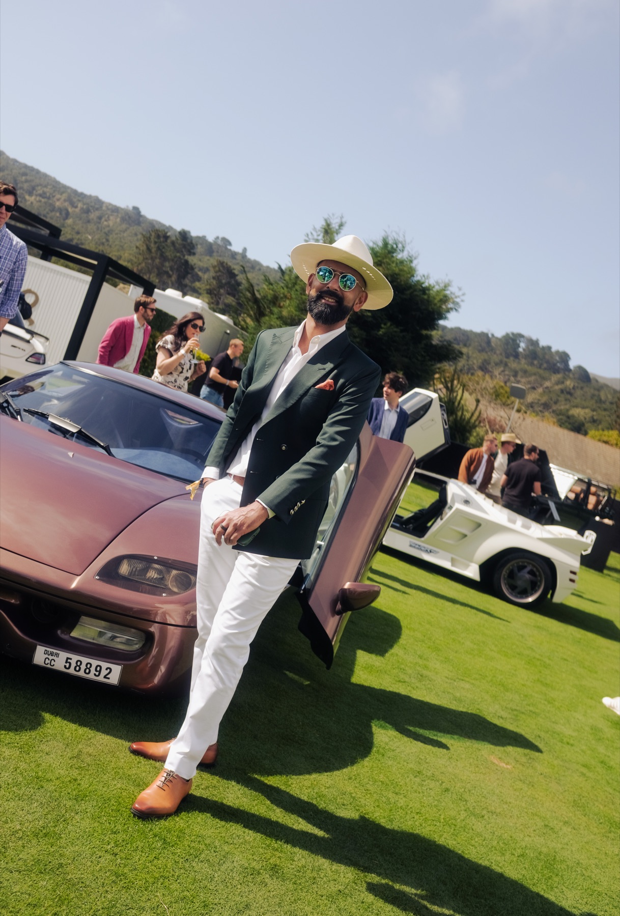 Gaurav Dhar beside the Koenigsegg CC prototype on the lawn at The Quail